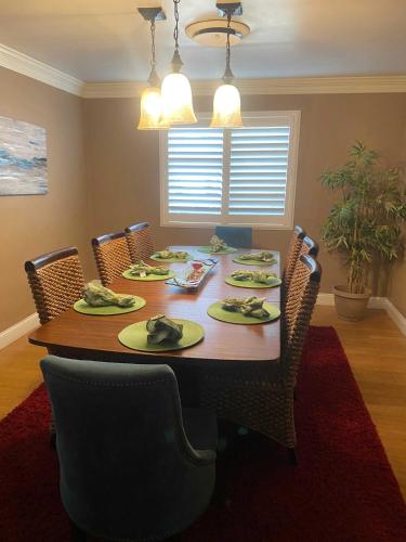 a dining room with a table with chairs and a dining room at Seq Parks-House with Hot Tub Fire Pit Koi Pond Outdoor Kitchen in Visalia