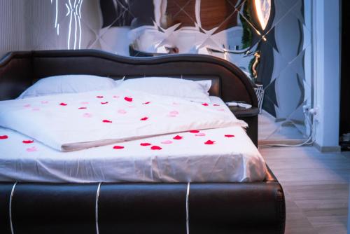 a bed with red hearts on it in a bedroom at 13Pacate By ElProfesor in Bucharest