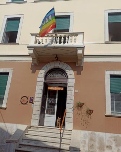 a flag flying over the door of a building at Ostello delle cartiere in Toscolano Maderno