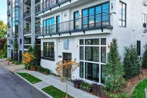an apartment building with balconies on a street at 121 Hotel Floor 1 Buyout by AvantStay Entire First Floor Buyout of 121 Hotel Sleeps 16 in Nashville