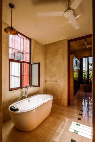 a large bathroom with a tub and a window at CASA EEB - 4BR Home Colonial Elegance Downtown Merida in Mérida
