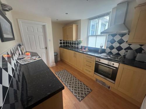 a kitchen with a counter and a stove top oven at The Hidden Hicks - Sleeps 2 in Whitehaven