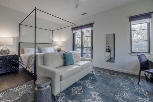 a living room with a white couch and a bed at 121 Hotel Floor 2 Buyout by AvantStay Entire Second Floor Buyout of 121 Hotel Sleeps 18 in Nashville