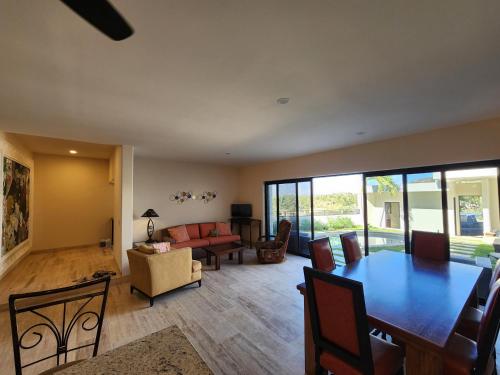 a living room with a dining table and a couch at Casa Vista Animas San Jose del Cabo in San José del Cabo