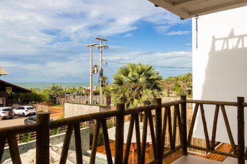 a balcony of a house with a palm tree at Casa Paradise - Condomínio Bali BG in Barra Grande