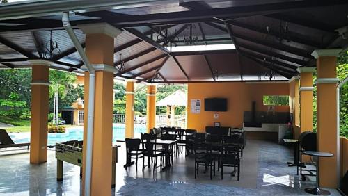 a restaurant with tables and chairs and a pool at Villa JR 4 near the Guacalillo Rock in Tivives