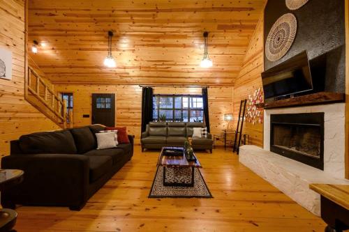 un salon avec un canapé et une cheminée dans l'établissement Sarah's Hideaway-Hot Tub Firepit & BBQ, à Stephens Gap