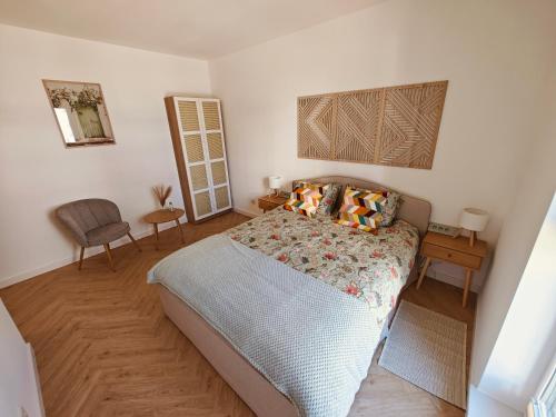 a bedroom with a bed and a table and chair at Amber Coast Apartment Gdańsk in Gdańsk