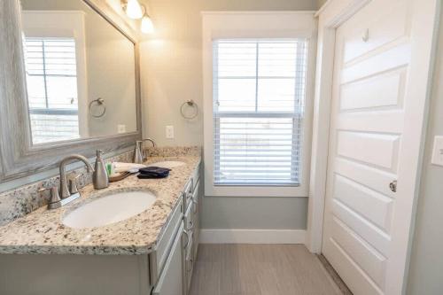 a bathroom with two sinks and a large mirror at A Gem in the Heart of Black Mountain in Black Mountain