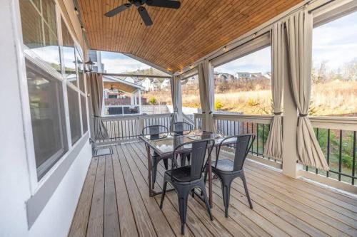a screened porch with a table and chairs on it at A Gem in the Heart of Black Mountain in Black Mountain