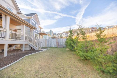 a house with a porch and a fence at A Gem in the Heart of Black Mountain in Black Mountain