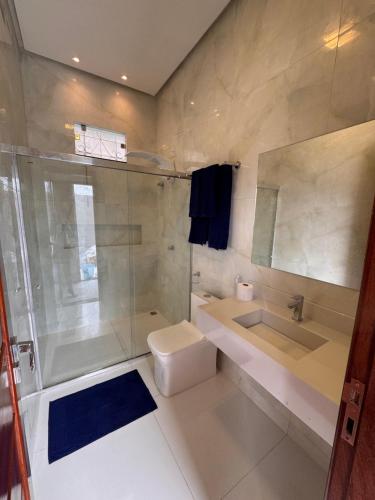 a bathroom with a shower and a toilet and a sink at Casa Alter do Sol - 3 suites in Alter do Chao