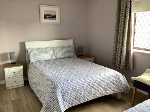 a bedroom with a bed and a window at Gala House Strandhill in Strandhill