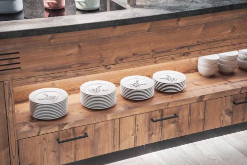 a bunch of plates on a shelf in a kitchen at BinderS Budget City-Mountain Hotel in Innsbruck