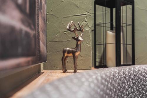 a small figurine of a deer standing on a table at BinderS Budget City-Mountain Hotel in Innsbruck