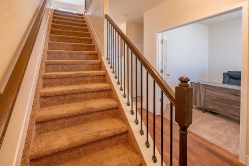 a staircase in a home with brown carpet at Newly Built 4BR Spacious Retreat in Peyton in Peyton