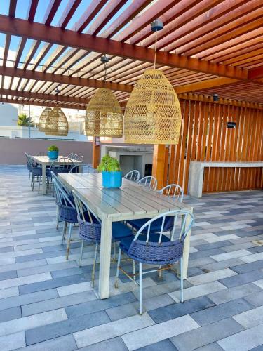 a table and chairs on a patio with lights at Beach condo in Tijuana