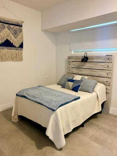 a bedroom with a bed with a wooden headboard at Beach condo in Tijuana