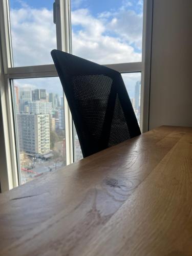 a chair sitting at a table in front of a window at Luxury apartment in the city center in Rotterdam