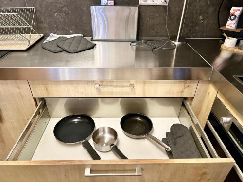 a kitchen with two pots and pans on a stove at Luxury apartment in the city center in Rotterdam