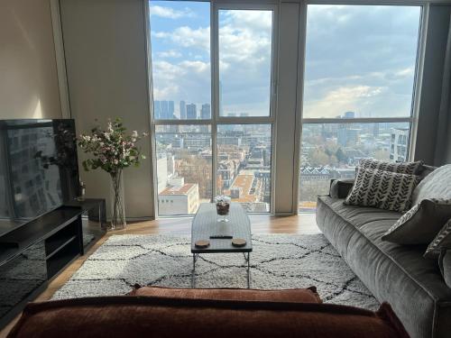 a living room with a couch and a large window at Luxury apartment in the city center in Rotterdam