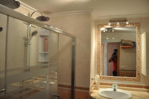 a person taking a picture of a bathroom with a sink at Studio Vue Mer in Torremolinos