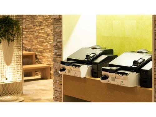 a group of four printers sitting on a shelf at The OneFive Sendai - Vacation STAY 45056v in Sendai