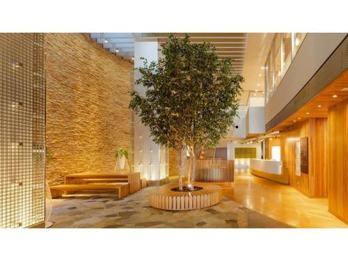 a tree in the middle of a lobby at The OneFive Sendai - Vacation STAY 45056v in Sendai