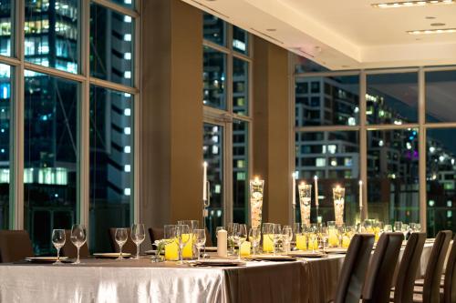 a long table with wine glasses on it in a building at SoHo Residences Toronto in Toronto