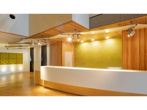 a large room with a white counter with lights at The OneFive Sendai - Vacation STAY 45045v in Sendai