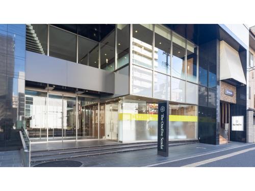 a glass building with a sign in front of it at The OneFive Sendai - Vacation STAY 45045v in Sendai