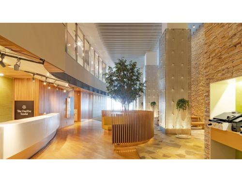 a lobby with a table and a tree in it at The OneFive Sendai - Vacation STAY 45014v in Sendai