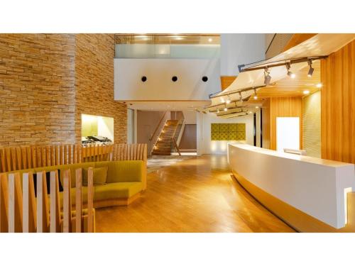 a living room with a couch and a staircase at The OneFive Sendai - Vacation STAY 45014v in Sendai