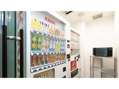 a refrigerator filled with lots of bottles of soda at The OneFive Sendai - Vacation STAY 45014v in Sendai