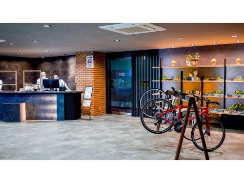 a restaurant with a bike parked in front of a counter at Hotel Area One Ise Inter - Vacation STAY 38393v in Ise