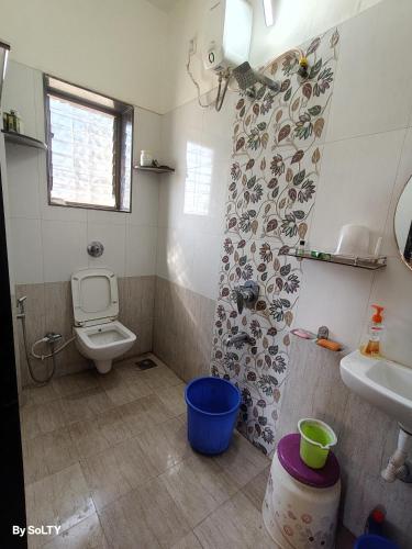 a bathroom with a toilet and a sink at Yogratna Classic in Pune