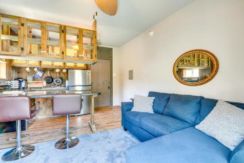 a living room with a blue couch and a kitchen at Charming New York Retreat with Lake Champlain Views! in Alburg