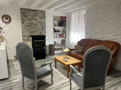 un salon avec un canapé, une table et des chaises dans l'établissement Family home, à Villedieu-sur-Indre
