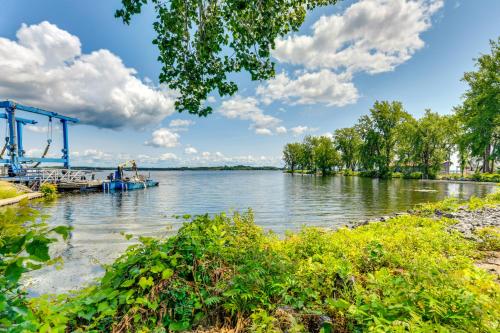 a river with a boat in the water at Charming New York Retreat with Lake Champlain Views! in Alburg