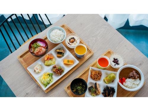 a table with plates of food and bowls of food at Hotel Area One Ise Inter - Vacation STAY 38519v in Ise