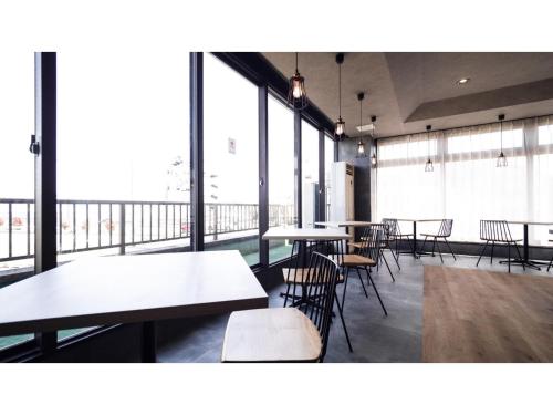a cafeteria with tables and chairs and large windows at Hotel Area One Ise Inter - Vacation STAY 38519v in Ise