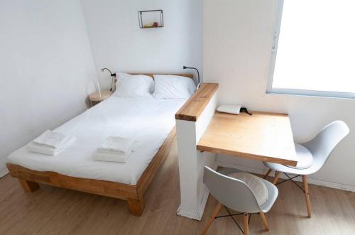 Ένα ή περισσότερα κρεβάτια σε δωμάτιο στο Boho Bispo Apartments