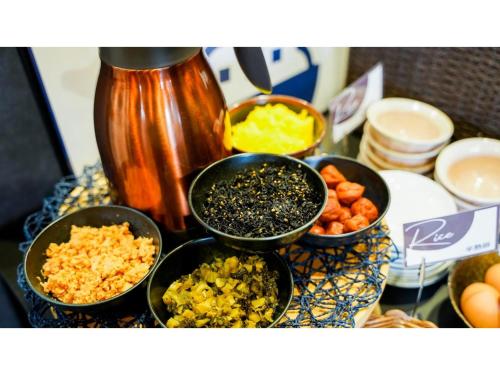 a table topped with bowls of different types of food at Hotel Area One Ise Inter - Vacation STAY 38525v in Ise