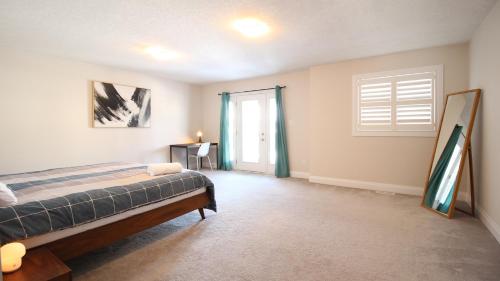 a bedroom with a bed and a window at Beautiful House Near Grand River & Kiwanis Park in Kitchener