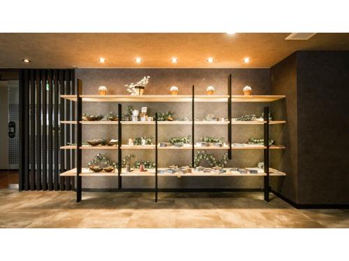 a shelf filled with vases and ornaments on it at Hotel Area One Ise Inter - Vacation STAY 38525v in Ise