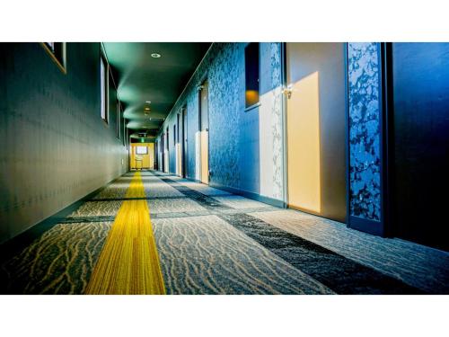 an empty hallway with blue and yellow walls at Hotel Area One Ise Inter - Vacation STAY 38525v in Ise