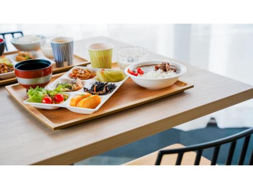 a table with plates of food and bowls of food at Hotel Area One Ise Inter - Vacation STAY 38481v in Ise