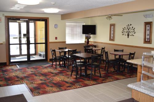 a dining room with tables and chairs and a flat screen tv at Budget Inn & Suites in Nevada
