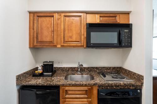 a kitchen with a sink and a microwave at DoubleTree by Hilton Houston Medical Center Hotel & Suites in Houston