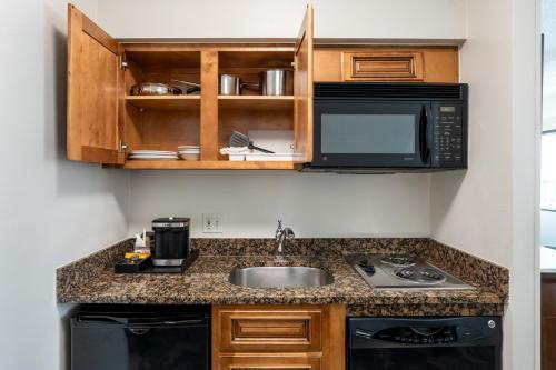 a kitchen with a sink and a microwave at DoubleTree by Hilton Houston Medical Center Hotel & Suites in Houston